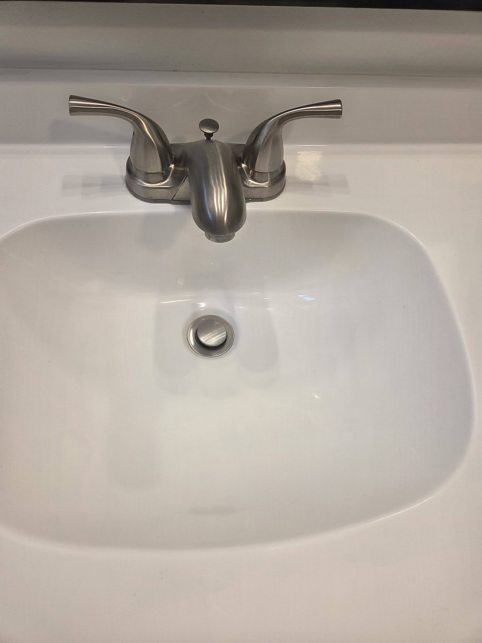 A bathroom basin polished clean